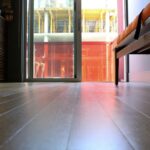 Interior view highlighting modern hardwood flooring and sunlight streaming through a glass door in victoria, bc, canada